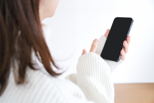 スマホ画面をタップしようとする手の画像